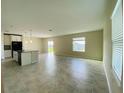 Spacious living room with tile flooring and sliding glass doors to the backyard at 2855 Alder Berry Blvd, Ocoee, FL 34761