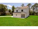 Two-story home with a well-manicured lawn presents a classic and inviting facade at 300 Mitnik Dr, Deltona, FL 32738