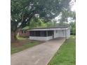 Charming single story home featuring a screened in porch and a long driveway at 3305 Robinson St, Zellwood, FL 32798