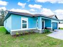 Lovely single-Gathering home featuring a covered entryway, well-maintained lawn, and an attached two-car garage at 527 Rio Grande Dr, Poinciana, FL 34759