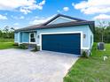 Beautiful home exterior with a brick-accented facade, lush lawn, and a convenient two-car garage at 527 Rio Grande Dr, Poinciana, FL 34759