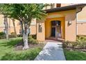 Apartment entrance featuring lush greenery, inviting signage, and convenient stair access for easy navigation throughout the complex at 5467 Vineland Rd # 6110, Orlando, FL 32811