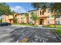 Inviting condo building with colorful facade, lush landscaping, and reserved parking spaces, creating an appealing curb appeal at 5467 Vineland Rd # 6110, Orlando, FL 32811