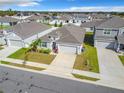 Aerial view of a well-maintained community showcasing manicured lawns, consistent design, and neighborhood streetscape at 554 Pawnee Ct, Haines City, FL 33844