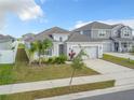 Attractive house with neat landscaping, a two-car garage, and a well-kept lawn with a beautiful blue sky background at 554 Pawnee Ct, Haines City, FL 33844