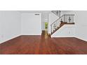Bright and open living room featuring wood floors and a staircase at 6052 Village Cir # 6052, Orlando, FL 32822