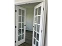 Elegant French doors with glass panels lead into a bright and inviting room at 611 Amazon Pl, Kissimmee, FL 34759