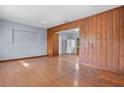 Spacious living room with blue walls, hardwood floors, and a wood accent wall at 641 Jackson St, Eustis, FL 32726