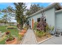 Quaint home with a stone walkway and vibrant landscaping, creating a welcoming entrance at 840 Del Prado Dr, Kissimmee, FL 34758
