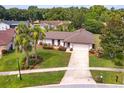 Aerial view of the charming home featuring mature landscaping, a long driveway, and serene neighborhood at 8988 Angelica Dr, Orlando, FL 32836