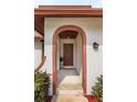 Welcoming front entrance with brick archway, elegant front door, and decorative wreath at 8988 Angelica Dr, Orlando, FL 32836