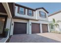 Three car garage of home with pavers at 9257 Outlook Rock Trl, Windermere, FL 34786
