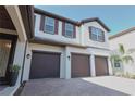 Three car garage of home with pavers at 9257 Outlook Rock Trl, Windermere, FL 34786