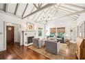 Bright living room featuring a fireplace, hardwood floors, vaulted ceiling, and cozy seating at 1008 Delaney Park Dr, Orlando, FL 32806