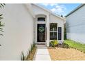 Inviting front door with decorative wreath and manicured front yard at 103 Gleason Cv, Sanford, FL 32773
