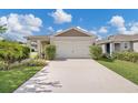 Charming single-story home boasts a well-maintained lawn and attached two-car garage, enhancing its curb appeal at 115 Duchess Rd, Deland, FL 32724