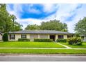 Charming single-story home featuring well-maintained landscaping and a welcoming facade on a sunny day at 1171 Covewood Trl, Maitland, FL 32751