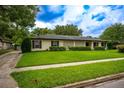 Classic single-story home with a lush lawn and mature trees, showcasing its curb appeal at 1171 Covewood Trl, Maitland, FL 32751