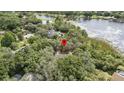 Aerial view featuring the roof with surrounding mature trees and a lake in the distance at 137 Hickory Ridge Cir, Lake Mary, FL 32746