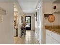 The tiled hallway features a coat closet, utility closet, and view of the doorway to the exterior at 14 Escondido Ct # 134, Altamonte Springs, FL 32701