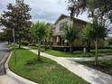 Charming exterior showcasing lush landscaping and manicured sidewalks at 14474 Prunningwood Pl, Winter Garden, FL 34787