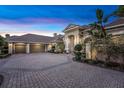 Home featuring a paved driveway leading to a spacious three-car garage with an arched entryway at 1810 Oakbrook Dr, Longwood, FL 32779
