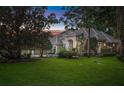 Charming single-story home with mature trees, lush green lawn, and neutral-toned exterior paint at 1810 Oakbrook Dr, Longwood, FL 32779