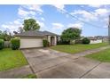 A single Gathering home with a well maintained lawn, a driveway, and mature trees at 2063 Killinger St, Deltona, FL 32738