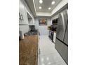 Galley kitchen featuring white cabinets, stainless steel appliances, and granite countertops at 2357 Rio Pinar Lakes Blvd, Orlando, FL 32822