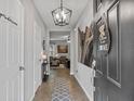 Inviting entryway with tile flooring, decorative lighting, and an artistic Eiffel Tower accent piece at 2620 Waterline St, Kissimmee, FL 34743