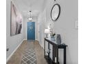 Welcoming entryway with neutral tones, tile flooring, and a decorative Eiffel Tower art piece at 2620 Waterline St, Kissimmee, FL 34743