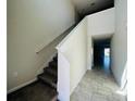 The foyer features a carpeted staircase and tiled floors that lead into the house at 2807 Alder Berry Blvd, Ocoee, FL 34761