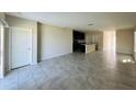Open floorplan with tile floors seamlessly connecting the living room and kitchen area at 2807 Alder Berry Blvd, Ocoee, FL 34761
