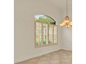 Arched window with plantation shutters letting natural light into the room at 289 Laurenburg Ln, Ocoee, FL 34761