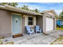 Inviting front porch featuring comfortable seating and a charming exterior with a one-car garage at 2943 Slippery Rock Ave, Orlando, FL 32826