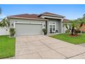 Attractive single-story house showcases a well-maintained lawn and a spacious two-car garage at 3813 Blue Dasher Dr, Kissimmee, FL 34744