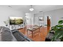 Spacious living room boasts hardwood floors, modern furnishings, and abundant natural light at 3813 Blue Dasher Dr, Kissimmee, FL 34744