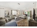 Spacious living room with stylish furniture, wood flooring, and bright windows at 4110 Boca Woods Dr, Orlando, FL 32826