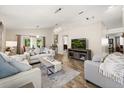Bright living room with vaulted ceilings, wood flooring, and modern decor at 4110 Boca Woods Dr, Orlando, FL 32826