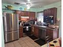 Traditional kitchen with stainless steel appliances and ceramic tile flooring at 4123 Gander Ave, Orlando, FL 32822
