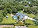 Expansive estate featuring a screened pool, lush landscaping, and a tranquil lake nearby at 4454 Aspenwood Ct, Orlando, FL 32835