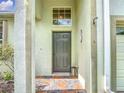 Front door of home with decorative tile and interesting window feature at 451 Acacia Tree Way, Kissimmee, FL 34758