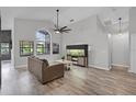 Bright living room with large window, high ceilings, and hardwood floors at 545 Hardwood Cir, Orlando, FL 32828