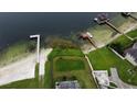 Aerial view showcasing the property's lakefront location, dock, and proximity to the water at 5529 Hansel Ave, Orlando, FL 32809