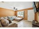 Cozy living room featuring neutral paint, tile flooring, and a comfortable sectional sofa at 6663 Nw 60Th St, Ocala, FL 34482