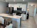 Bright, updated kitchen featuring stainless steel appliances, quartz countertops and a center island at 6841 Wilson Hammock Ave, Groveland, FL 34736