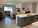 Open-concept kitchen and dining area with a view into the cozy living room at 6841 Wilson Hammock Ave, Groveland, FL 34736