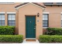 Inviting front door in a stucco home with manicured landscaping, a secure door, and great curb appeal at 730 Siena Palm Dr # 201, Celebration, FL 34747