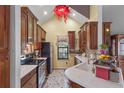 Traditional kitchen boasts wooden cabinets, stainless steel appliances, and ample counter space for cooking at 730 Siena Palm Dr # 201, Celebration, FL 34747
