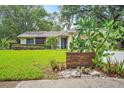 Charming single Gathering home featuring desert landscaping and house number sign, front lawn in view at 7806 Compass Dr, Orlando, FL 32810